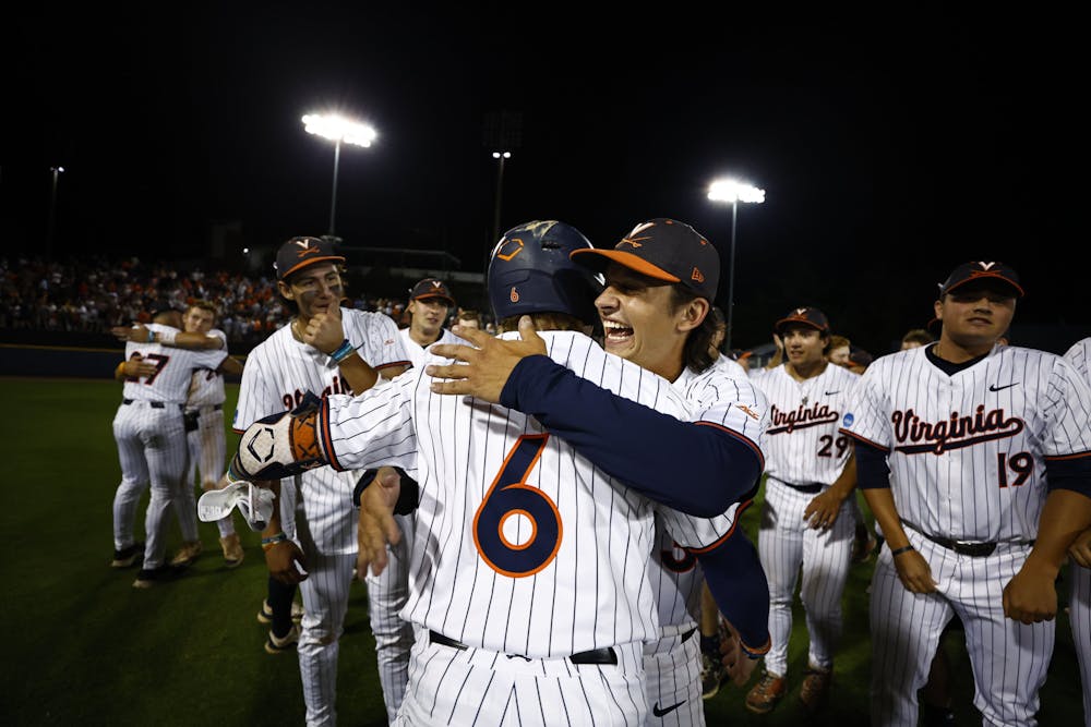 Virginia players celebrate in the outfield of Disharoon Park following Saturday night's walk-off victory.