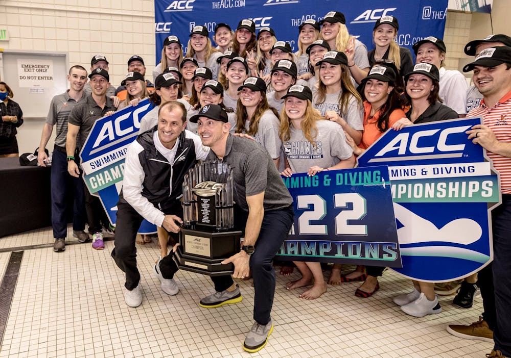 Coach Todd DeSorbo celebrates with the women's team as they take home their third straight ACC Championship trophy.